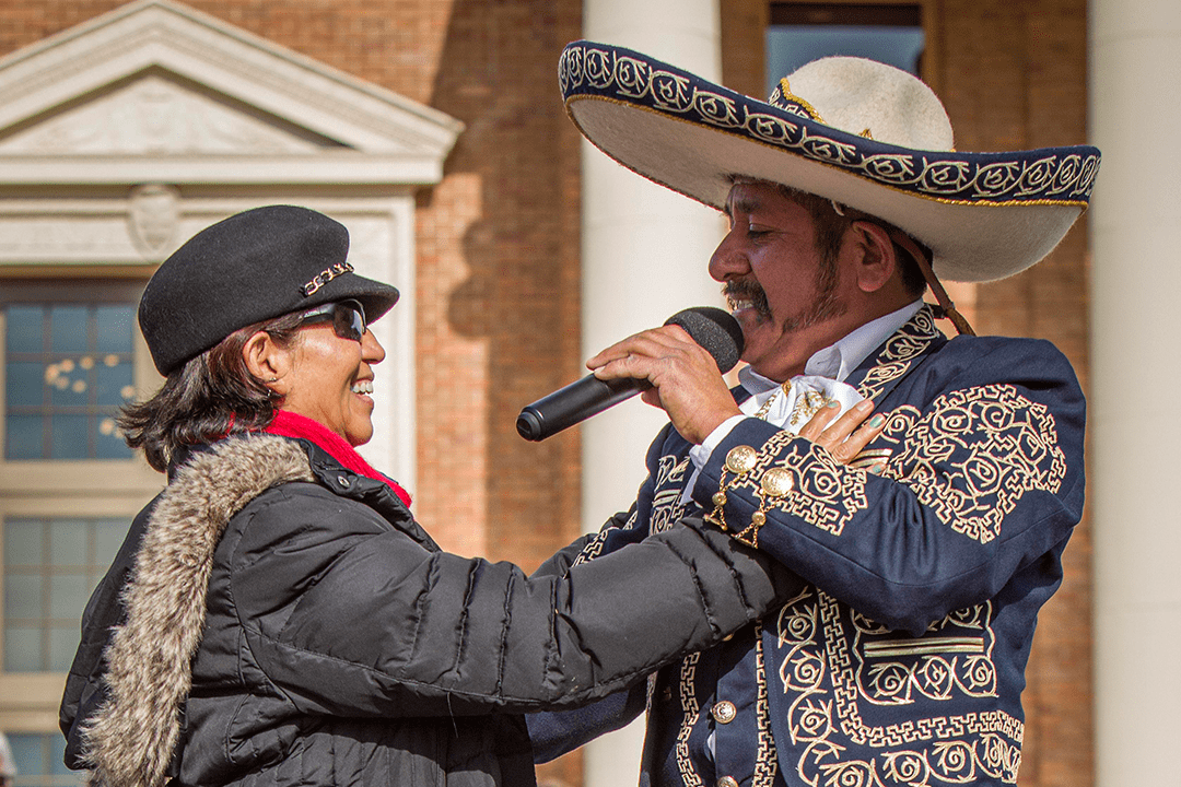 Image of Manuel Enrique singing to and dancing with a woman attending the 2020 Tamale Festival - Photo by Keith Bergher